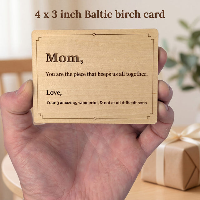 Hand holding a 4 x 3 inch engraved wood message card with a short message to a mother, showing its real size