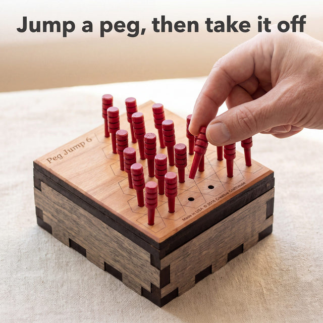 Adult hand lifting a jumped red peg off the Peg Jump 6 board after the first move. Headline: Jump a peg, then take it off.