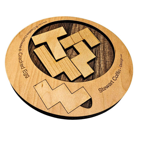 Cracked Egg wooden dissection puzzle with loose shaped pieces in and beside an oval frame