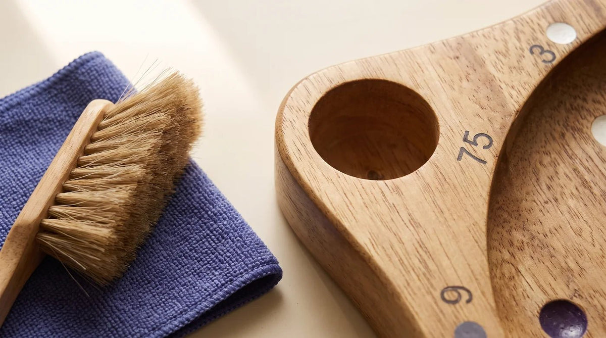Close detail of a Math Roulette corner well beside a soft dusting brush and folded dry cloth