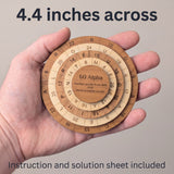 The 60 Alpha puzzle resting in an open adult palm to show its size. Headline: 4.4 inches across. Instruction and solution sheet included.