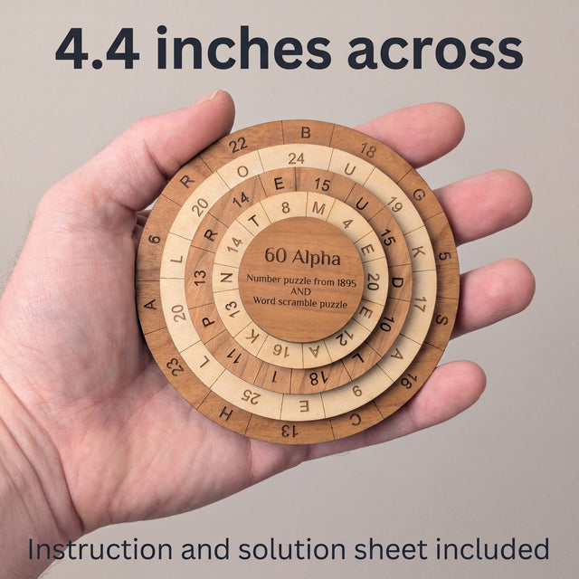 The 60 Alpha puzzle resting in an open adult palm to show its size. Headline: 4.4 inches across. Instruction and solution sheet included.