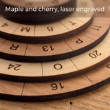 Close up of the laser engraved numbers and letters on the stepped maple and cherry rings of the 60 Alpha puzzle. Headline: Maple and cherry, laser engraved.