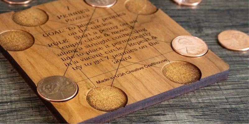 7 Pennies wooden brain teaser with pennies on a wood table.