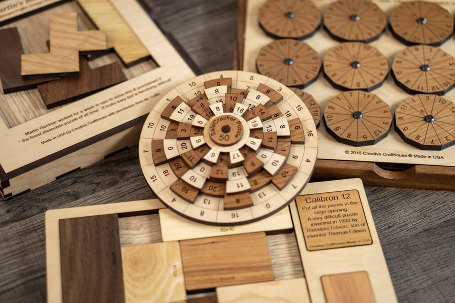 The Martin's Menace, Calibron 12, and dodecagon wooden brain teasiers from the Impoissble Puzzle Series from Creative Crafthouse. The Safecracker 50 math puzzle is also shown in the middle.