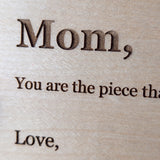Close up of laser engraved serif lettering burned into pale Baltic birch wood grain on a Wood Message Card