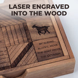 Close detail of the laser engraving on the Get My Goat raintree blocks: the goat silhouette, the instruction By sliding blocks, move the goat inside the octagon, and engraved line patterns, with the tray seated in the notched wood cover. Headline: Laser engraved into the wood.