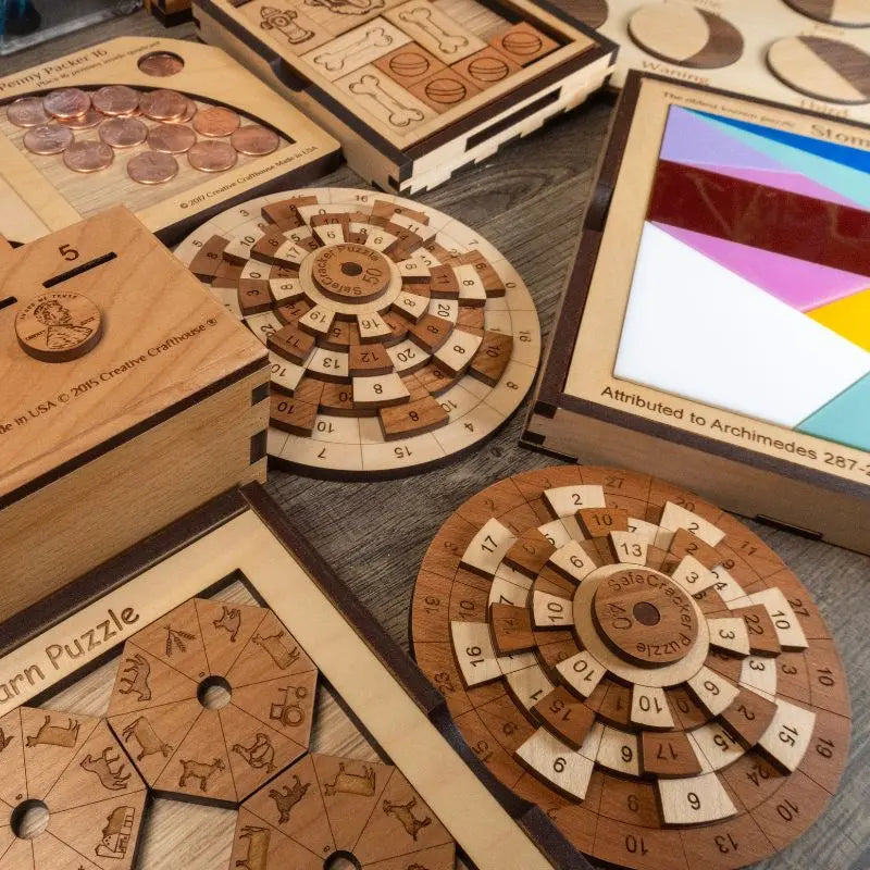 A selection of wood puzzles and games made by creative crafthouse on a table.