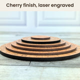 Low side photo of the five stepped cherry-veneer disks of the Mexican Army Cipher Wheel with dark laser-cut edges