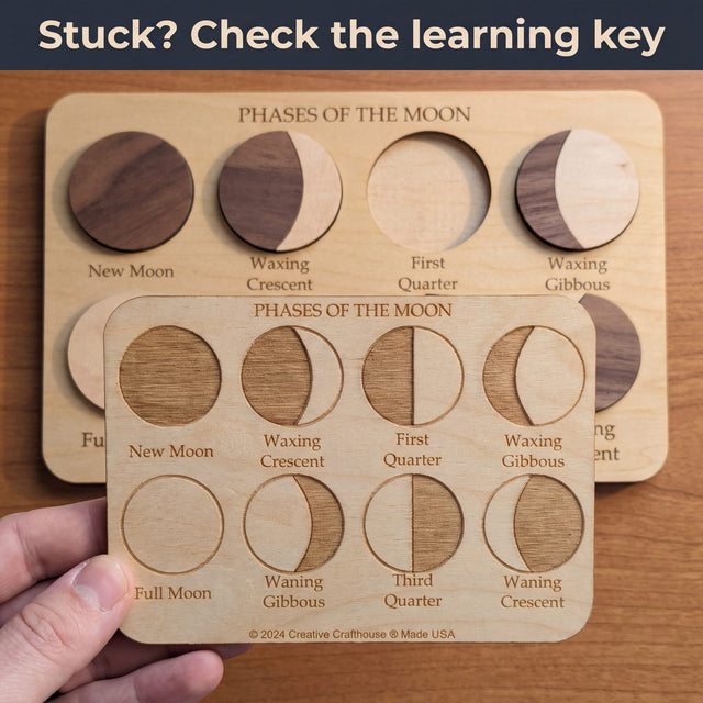 Hand holding the engraved Moon Phases learning key over the puzzle board to check each phase. Headline: Stuck? Check the learning key.