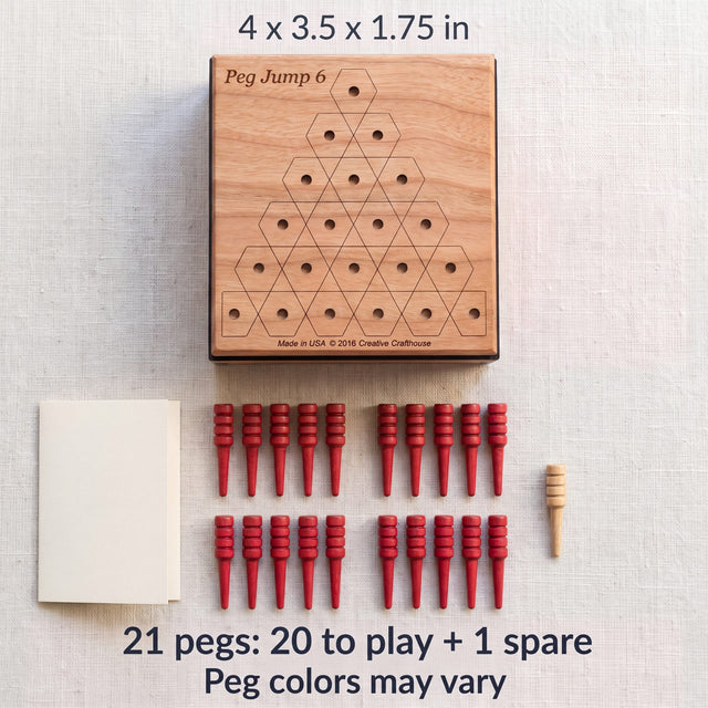 Peg Jump 6 contents: the 4 x 3.5 x 1.75 inch box with cherry lid, 20 red pegs, one natural spare peg and the instruction sheet. Peg colors may vary.