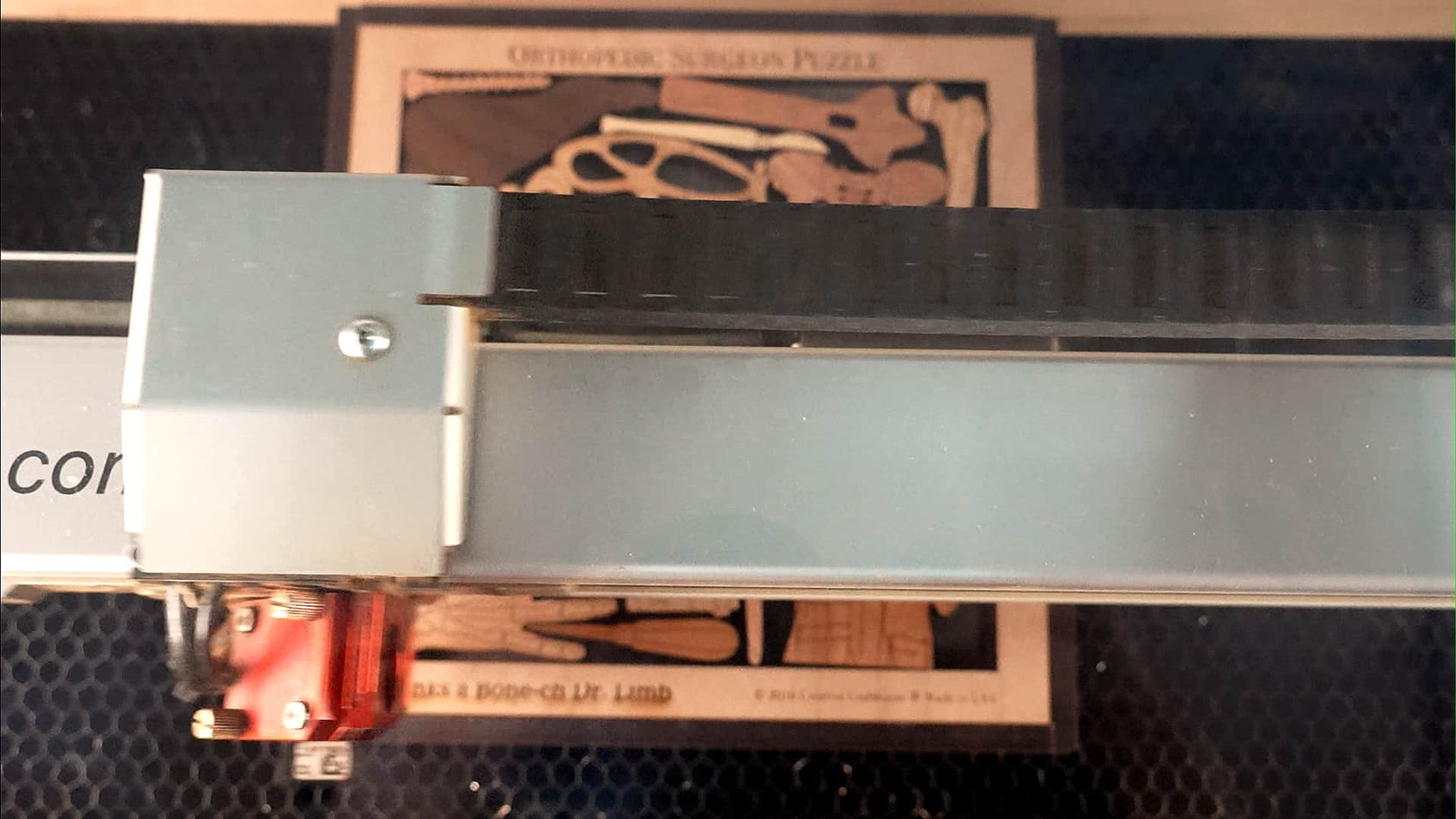 a puzlle being laser engraved with personalized text by creative crafthouse