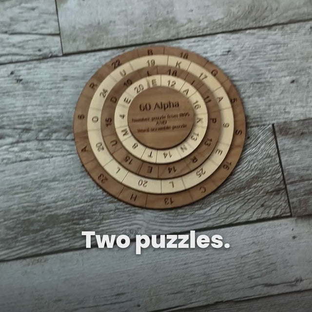 Hands turn the maple and cherry rings of the 60 Alpha puzzle on a grey wood surface, with captions explaining the number puzzle, where every column must total 60, and the word puzzle, where every column of letters spells a word.