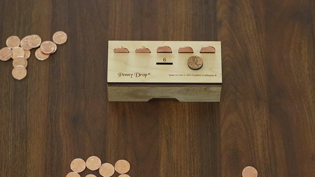 How to play Penny Drop, the wooden dice game by Creative Crafthouse: an animated Original Premium board and real play footage teach each rule, from rolling for first turn to the take-back and the odds of busting