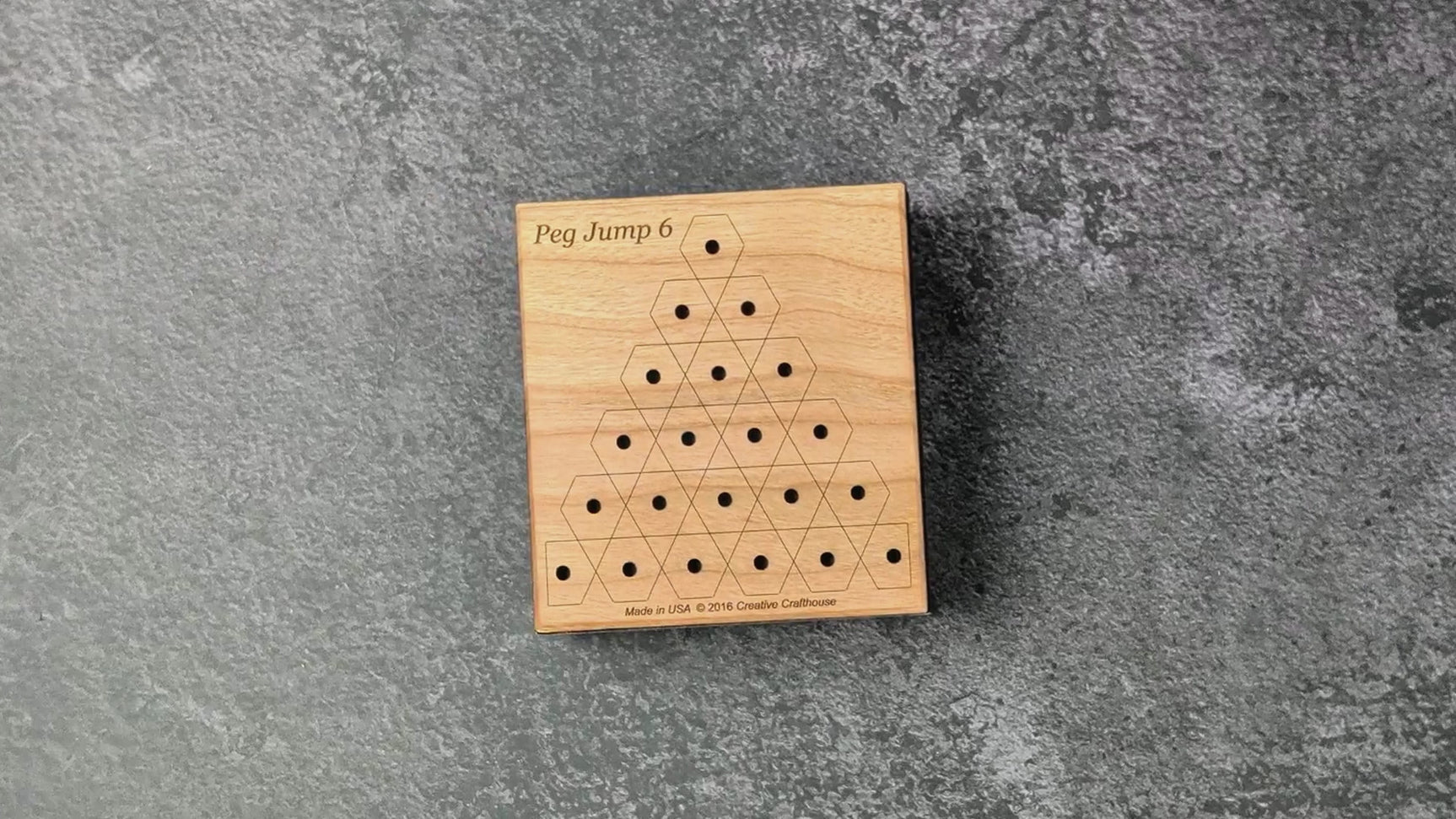 Peg Jump 6 in use: the closed box and engraved cherry lid, the loaded board lifted in hand, a game started from one empty hole with jumped pegs taken off, then the lid sliding shut over the stored pegs.