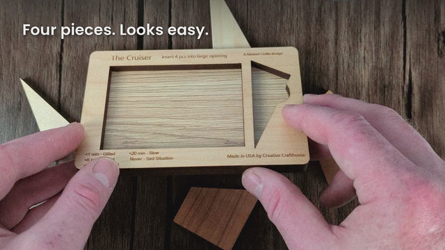 Cruiser video: hands try to fit four pieces into the tray, Stewart Coffin design #167, ending on our Hudson, Florida card