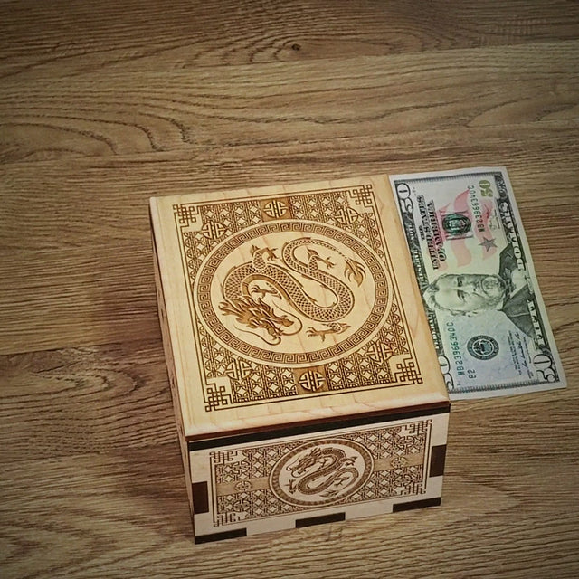 Dragon Hurricane Box video by Creative Crafthouse: hands open the laser-engraved maple puzzle box with Chinese dragon artwork to reveal the hidden compartment, closing with the handmade in Hudson, Florida family card.
