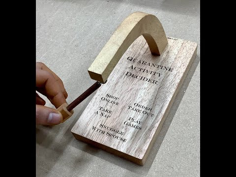 Video of the Quarantine Activity Decider by Creative Crafthouse in standard and custom models: the pendulum swung over the engraved answers, the red felt underside and the one-screw arm assembly