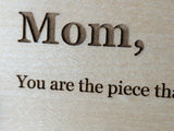 Close view of the laser engraved serif lettering on a Baltic birch Wood Message Card, with dark letters set into the fine wood grain